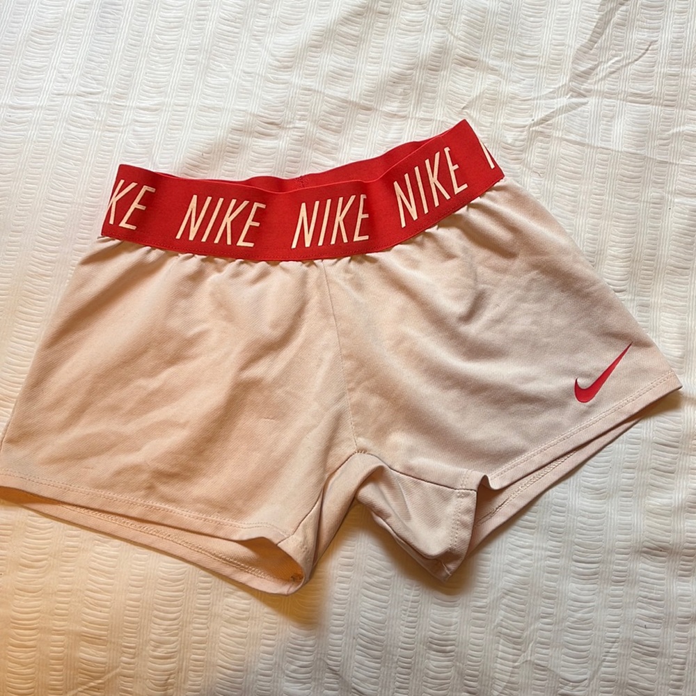 Girls Nike Dri-Fit shorts. Size small in girls.Pinkish coral color.